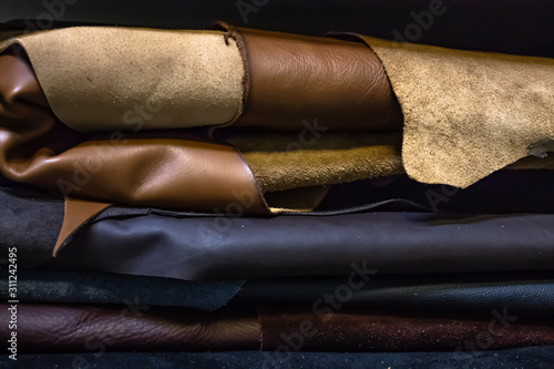 Rolls of genuine leather in the workshop. Convolutions of vegetable tanned leather.