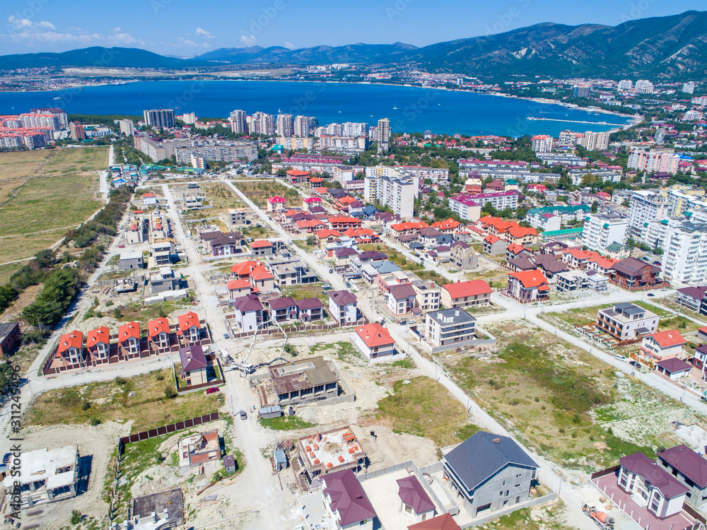 Construction of cottages in the seaside town.  Houses on the shore of Gelendzhik Bay. Aerial view. 
