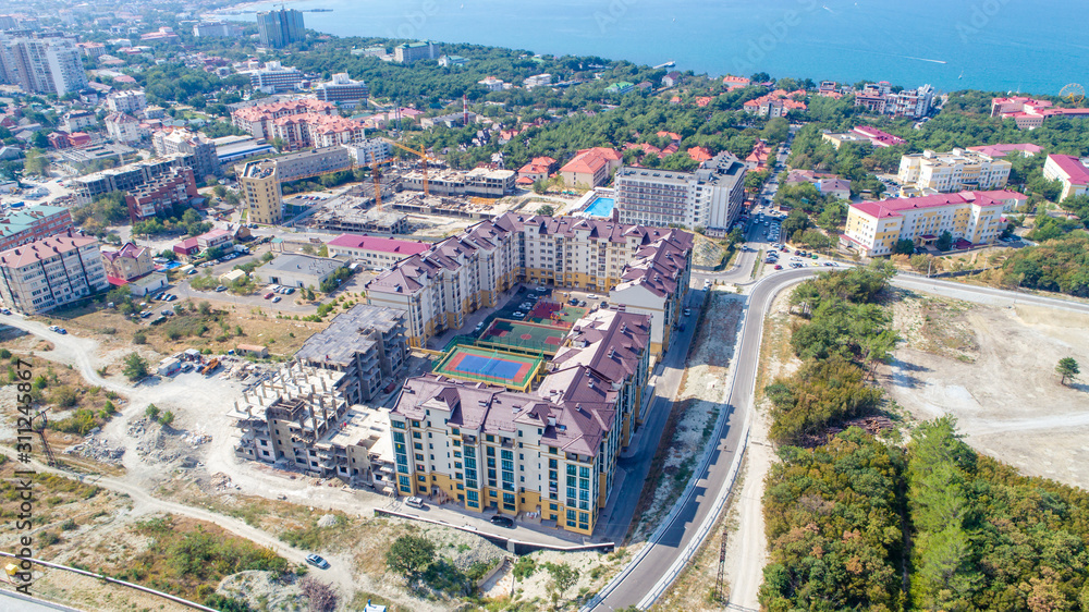 Several buildings of the residential complex are already ready One house is under construction. In the middle of a residential copmlete Playground. In the background sea, Bay