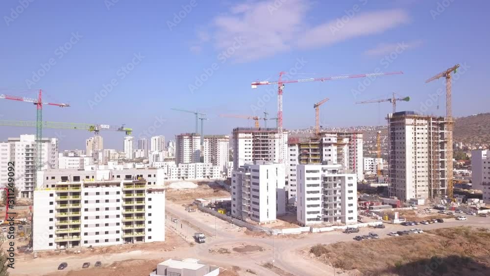 Residential construction site. Tower cranes build large residential buildings. Aerial view of new city construction site. Residential construction site. Tower cranes build large residential buildings. Aerial view of new city construction site.