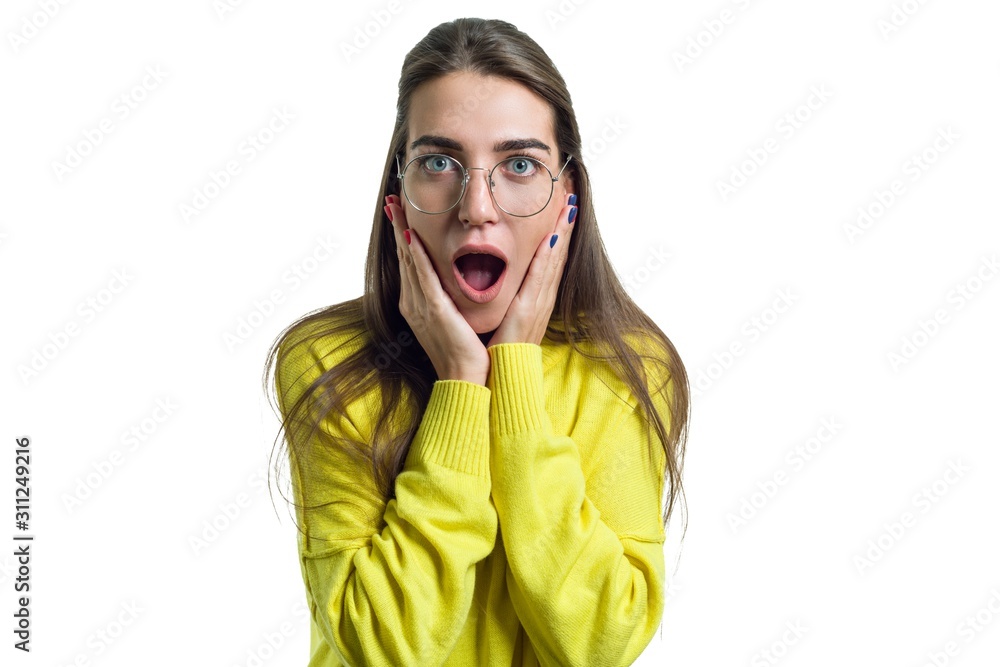 Young surprised woman in glasses yellow clothes on white isolated background Young surprised woman in glasses yellow clothes on white isolated background