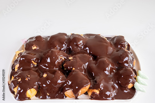 Homemade Profiterole, french and italian dessert, cream puff, with chocolate sauce.