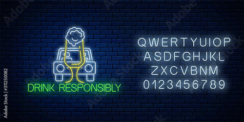 Glowing neon sign of drink responsibly call with car silhouette and glass of beer with alphabet. Prevent drunk driving