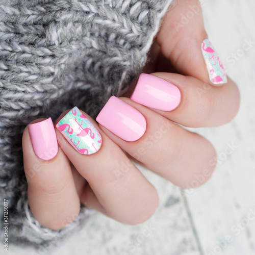 Pink manicure with pink flamingo pattern with gray sweater