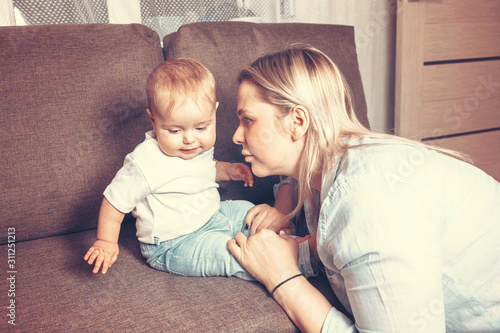 The first year of life of the mother and baby in the family. Mom with a small child in her arms. problems of mutual understanding