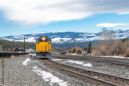 A train crossing in Truckee, Nevada, with snowy mountains in background