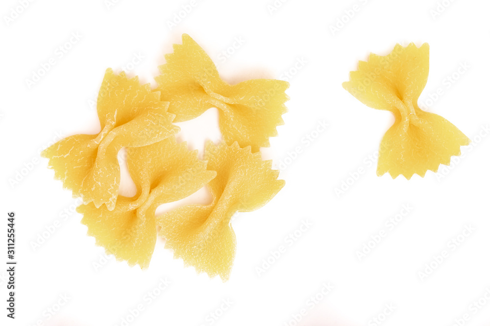 Italian raw Pasta Farfalle scattered on a white background. Close up. Italian raw Pasta Farfalle scattered on a white background. Close up.