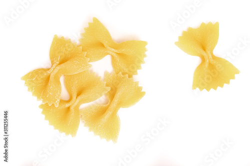 Italian raw Pasta Farfalle scattered on a white background. Close up.