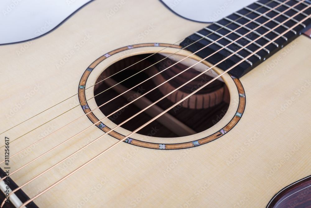 wood texture of lower deck of six strings acoustic guitar on white background. guitar shape wood texture of lower deck of six strings acoustic guitar on white background. guitar shape