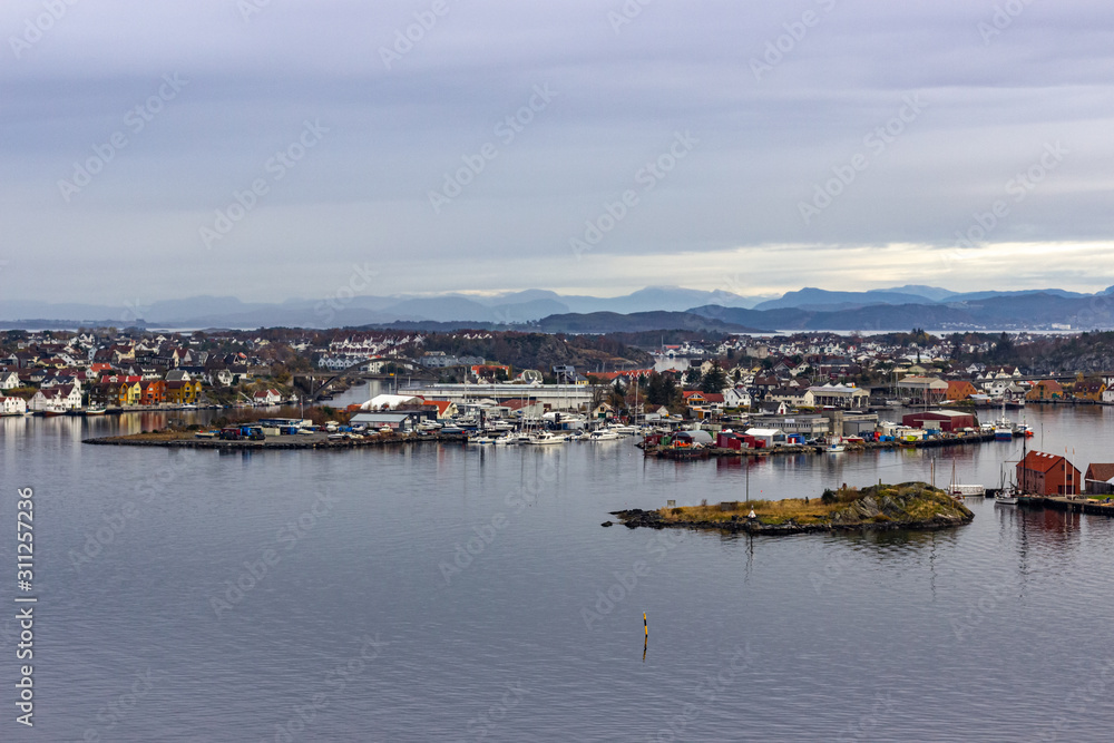 View on the islands of Stavanger city with mountains in the distance on a cloudy day, Norway