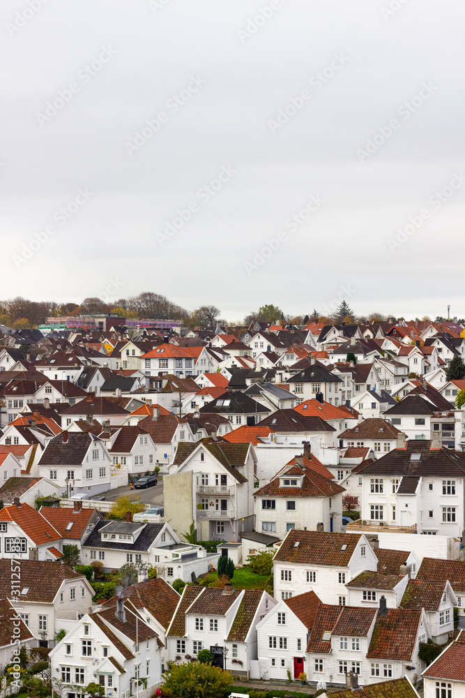 Fototapeta premium Thousands of white houses with red rooftops are the historic district in Stavanger called Gamle Stavanger (Old Stavanger), Norway