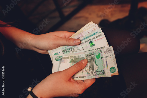 Man in skirt holds Russian rubles banknotes. Financial theme. Horizontal view. photo