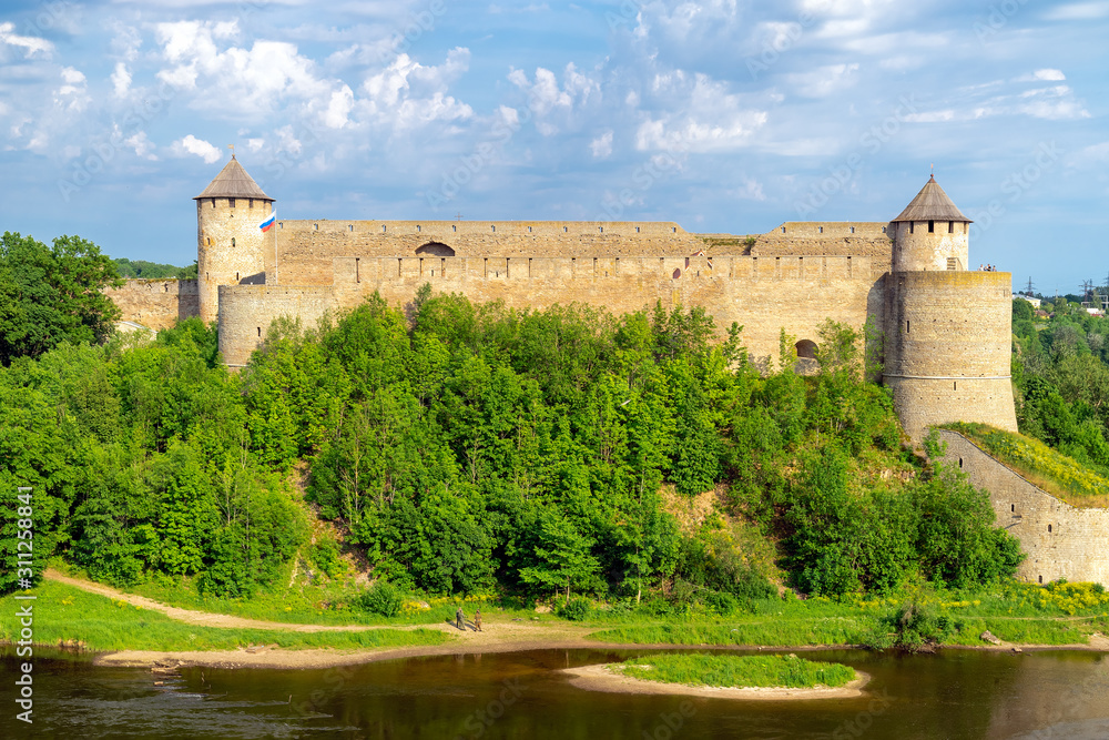 The view of the medieval fortress in Ivangorod, Russia,  on the right Bank of the Narva river from Narva castle in Estonia. Copy space
