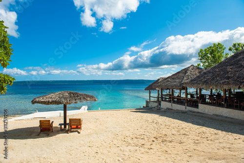 Two deck chairs on a sandy beach in Vanuatu. Copy space for text.