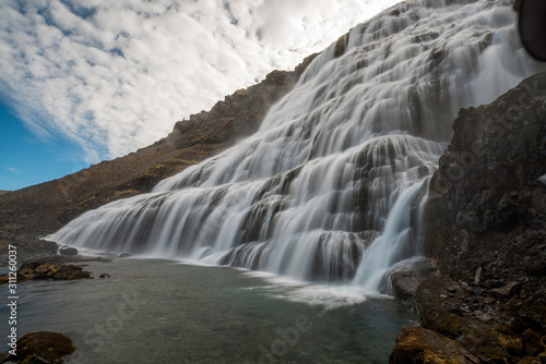 Dynjandi or Fjallfoss big and powerfull waterfall cascade in the westfjords of the Icelandic wilderness during daytime. Waterfalls, traveling and iceland concept.