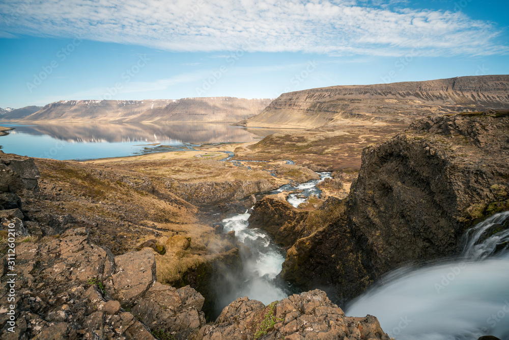 Dynjandi or Fjallfoss  big and powerfull waterfall cascade in the westfjords of the Icelandic wilderness during daytime. Waterfalls, traveling and iceland concept.