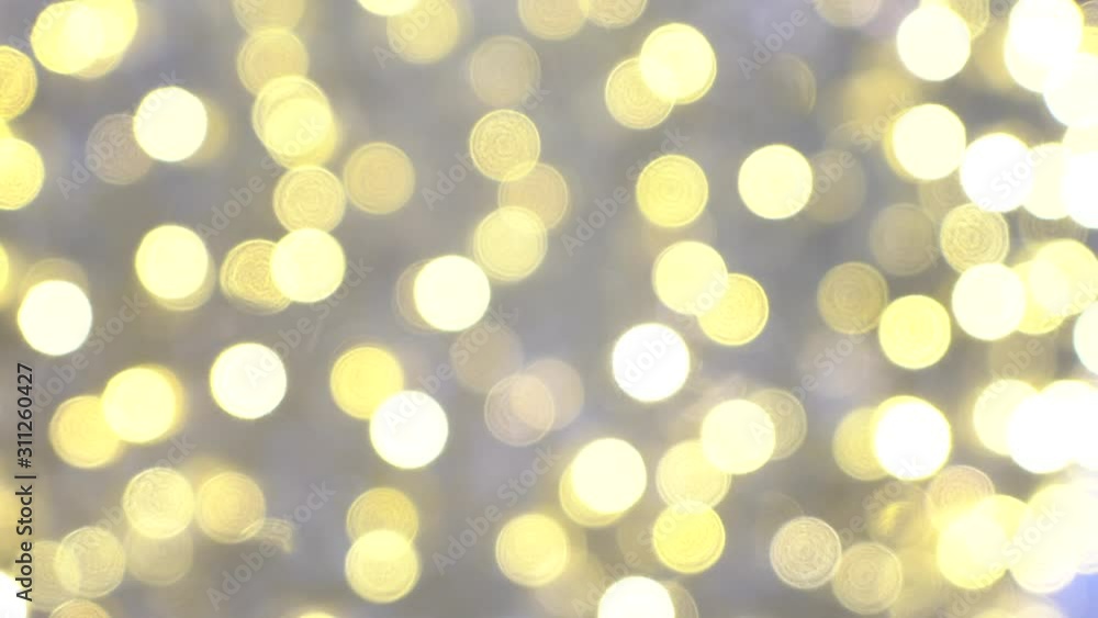 A bright garland with unfocused yellow bokeh balls for Christmas. New year holidays background with shiny lights. Real lens blur of bright winter party. A bright garland with unfocused yellow bokeh balls for Christmas. New year holidays background with shiny lights. Real lens blur of bright winter party.