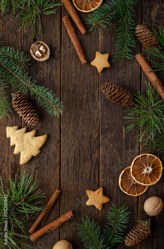 Christmas decoration with fir tree branches on wooden background, copy space