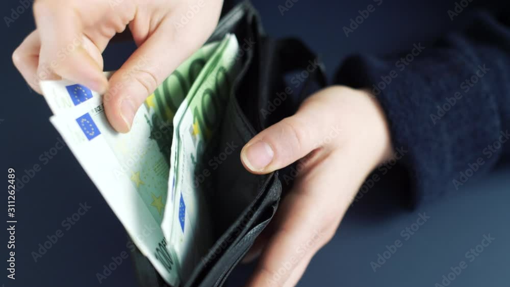 Counting money in a black leather wallet. Close up 4k slow motion footage. Counting money in a black leather wallet. Close up 4k slow motion footage.