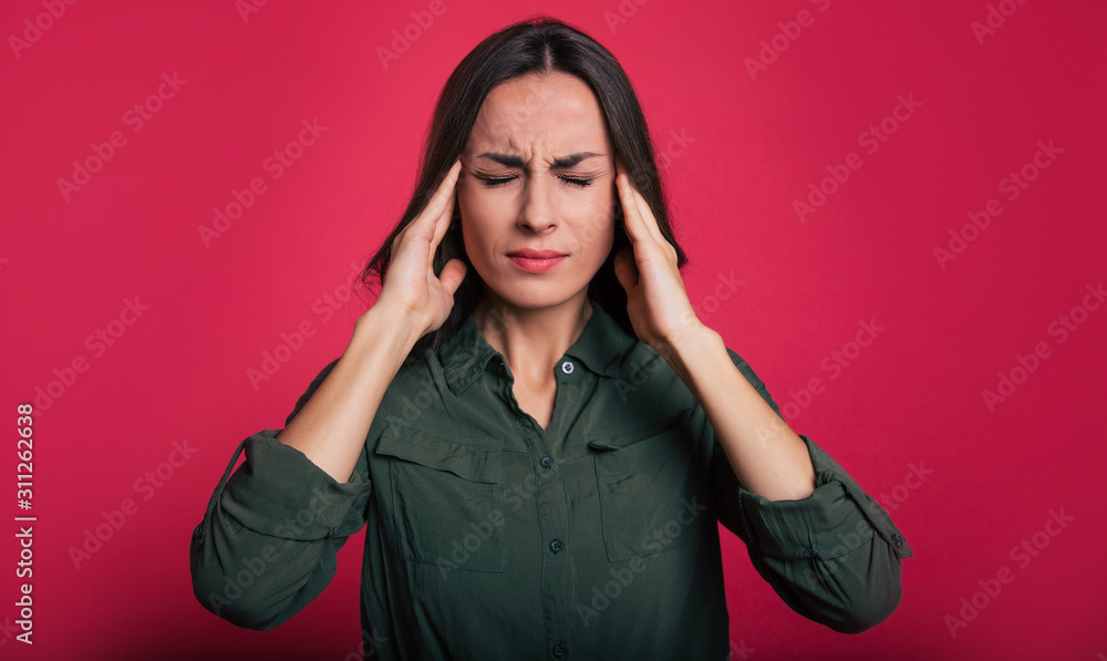 Having a lot on your mind. Full-face portrait of a girl, who is facing the camera with her eyes closed and her fingers touching temples as a sign of stress or headache. Having a lot on your mind. Full-face portrait of a girl, who is facing the camera with her eyes closed and her fingers touching temples as a sign of stress or headache.