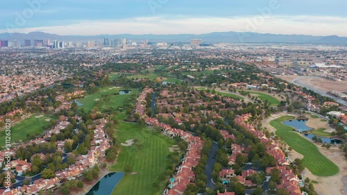Aerial pullback shot of Las Vegas residential community, houses,  golf course