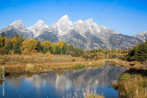 Snow Capped mountains reflected in the Snake River