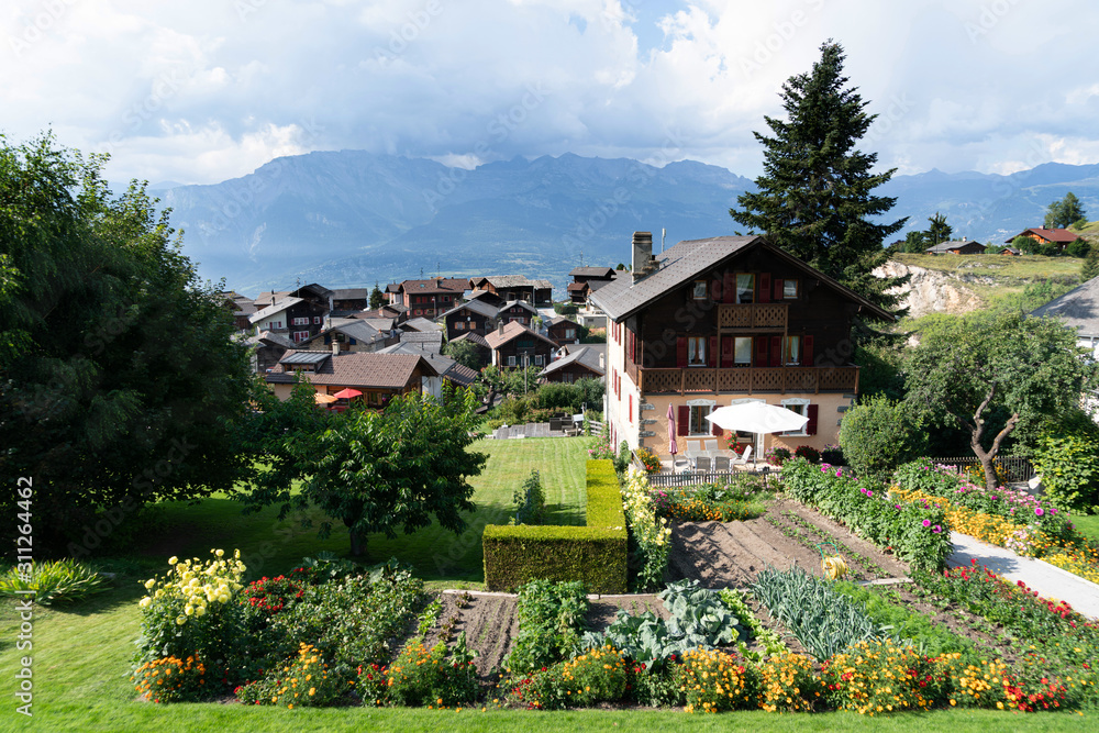 View from a Vegetable garden over the Nax village, Suiss alps in background, Switzerland View from a Vegetable garden over the Nax village, Suiss alps in background, Switzerland
