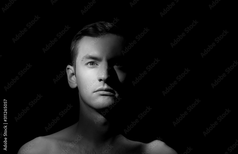 black and white dramatic portrait of a guy close-up on a black background with one light source black and white dramatic portrait of a guy close-up on a black background with one light source