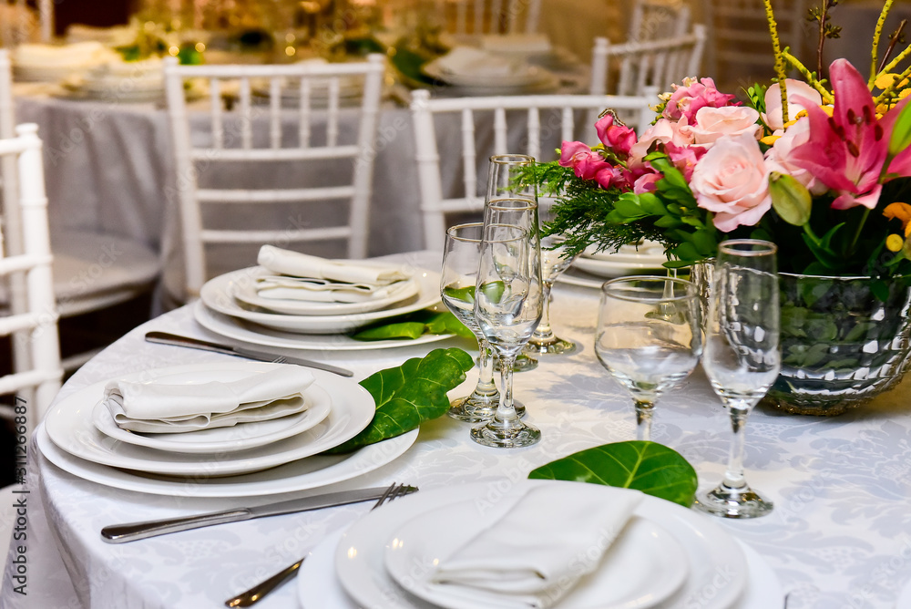 Elegant table setting with flowers and cups, natural flowers Elegant table setting with flowers and cups, natural flowers