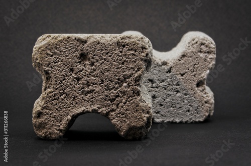 grey concrete spacers isolated on black background photo