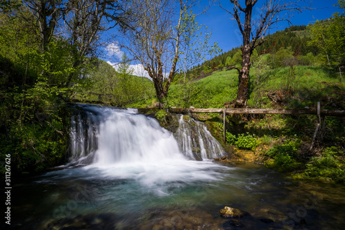 Waterfall on a mountain river in spring.