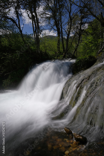 Waterfall on a mountain river in spring.