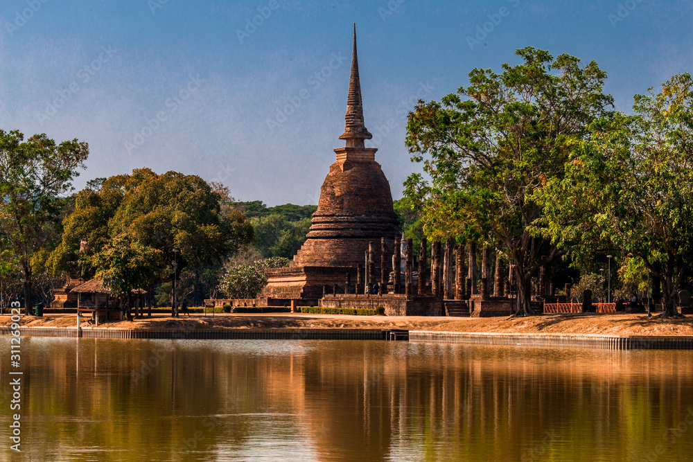 Background Historical sites in Sukhothai, with ancient Buddha images. Tourists around the world favor visiting Thailand.
