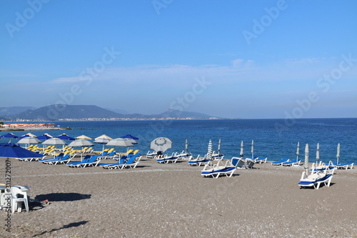 beach with umbrellas © Matvejs