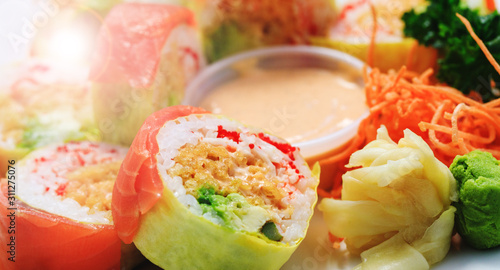 Sashimi sushi in close up picture. Shrimps with rice and parsley in close-up image. Plate of seafood. Fresh and delicious maki and nigiri sushi and sake glass.