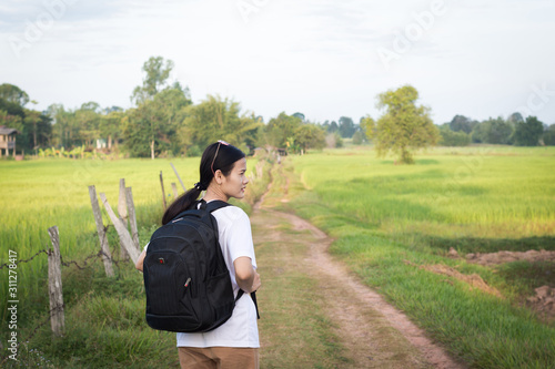 Traveler woman with backpack go to countryside.