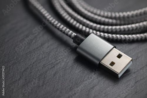 USB type A plug with cable on the black rock.