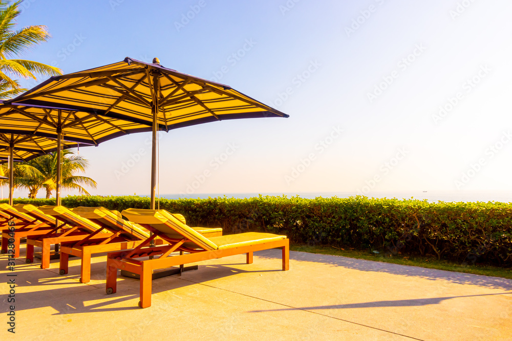 Umbrella and chair around outdoor swimming pool in hotel and resort Umbrella and chair around outdoor swimming pool in hotel and resort