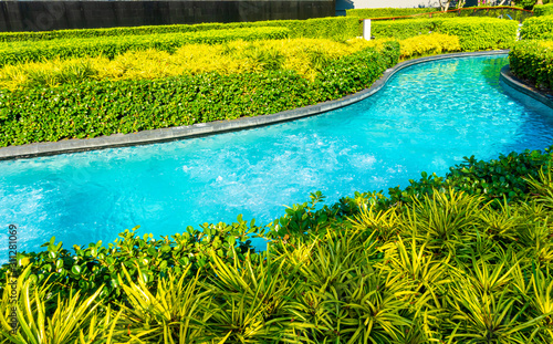 swimming pool in garden decoration in hotel resort
