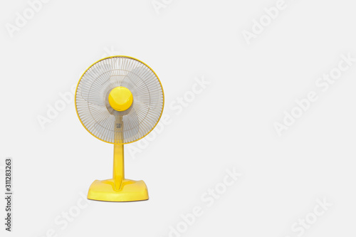 Electric Yellow table fan isolated on white background photo