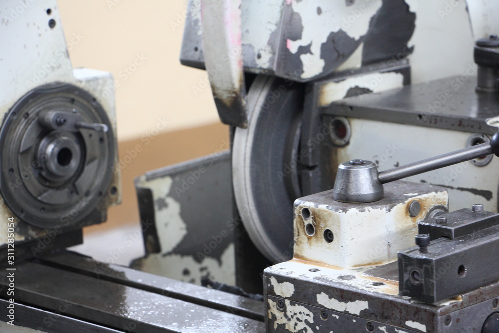 Naklejka premium Deadhead draw chuck and grinding disk on turning lathe grinder machine tool on spindle headstock background, industrial metal working