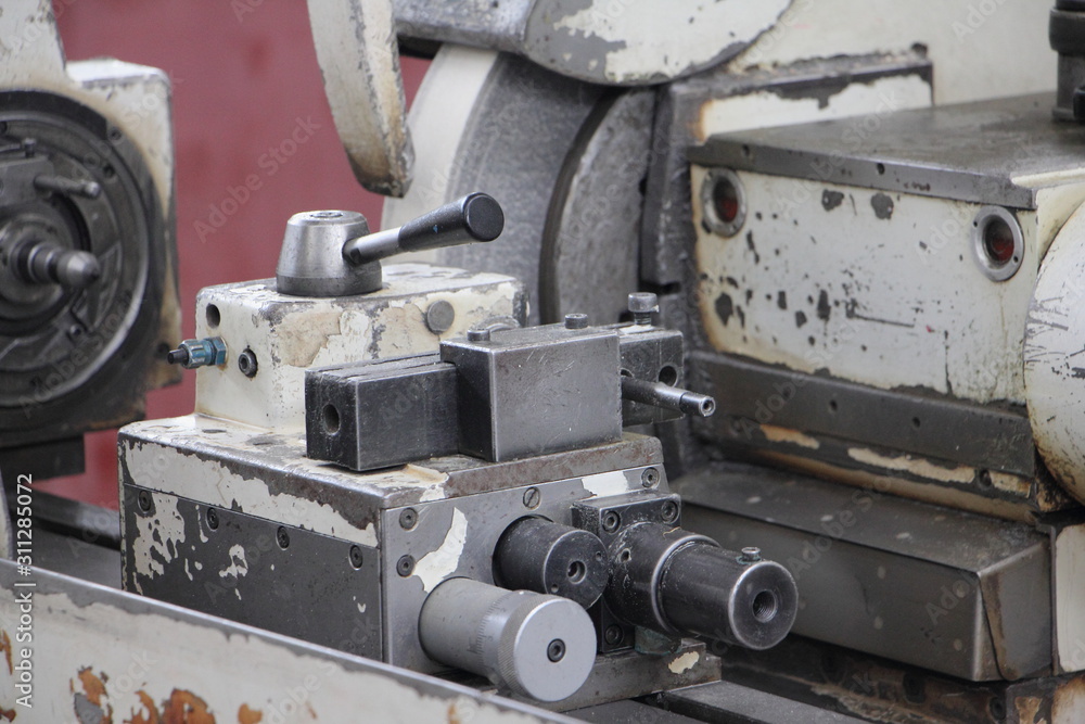 Close up tail block draw chuck of turning lathe grinder machine tool on spindle headstock background, industrial metal working Close up tail block draw chuck of turning lathe grinder machine tool on spindle headstock background, industrial metal working