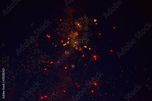 red and yellow fireworks on a black background 