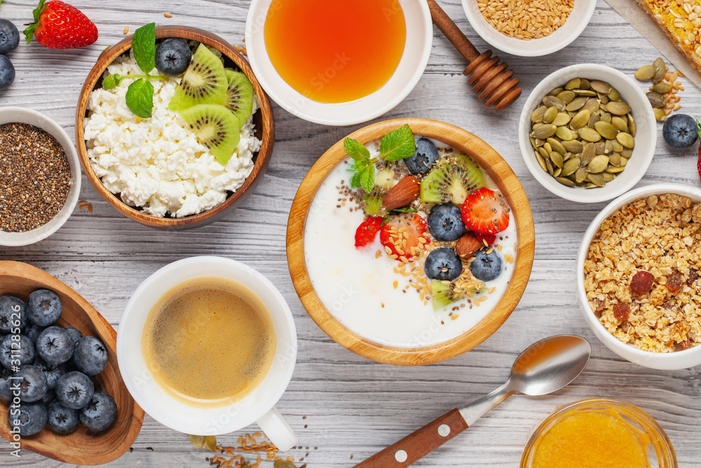 Healthy breakfast set with yogurt, berries, coffee and granola. Top view. Flat lay Healthy breakfast set with yogurt, berries, coffee and granola. Top view. Flat lay
