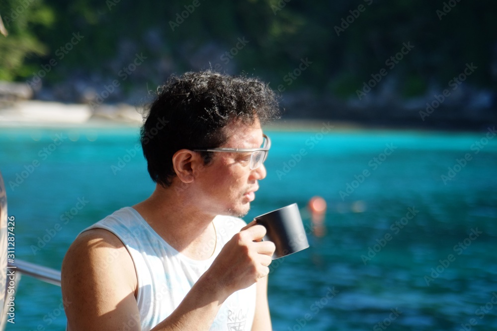 man drinking coffee​ on​ ship​ sea
