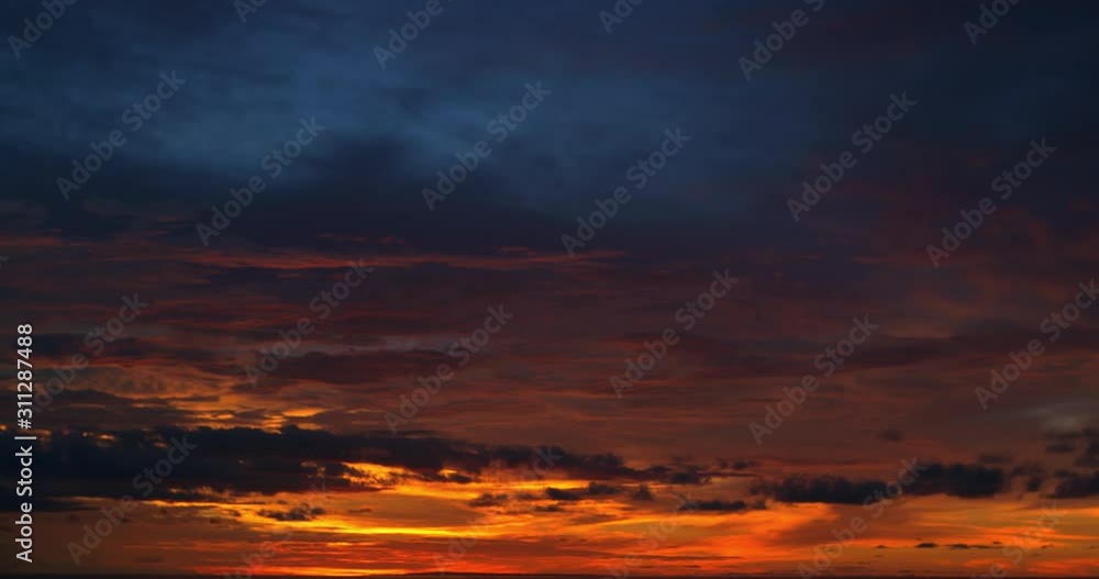 Ocean panorama. Dark orange clouds day to night sky. Dramatic sunset over storm clouds. Beautiful red color sky. Red purple orange blue pink sunset cloud background. Concept holiday in the tropics. Ocean panorama. Dark orange clouds day to night sky. Dramatic sunset over storm clouds. Beautiful red color sky. Red purple orange blue pink sunset cloud background. Concept holiday in the tropics.