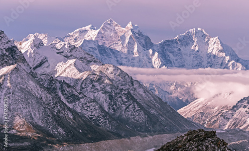 Majestic Himalayan peaks towering above the clouds at sunrise in Nepal, Himalayas mountains photo