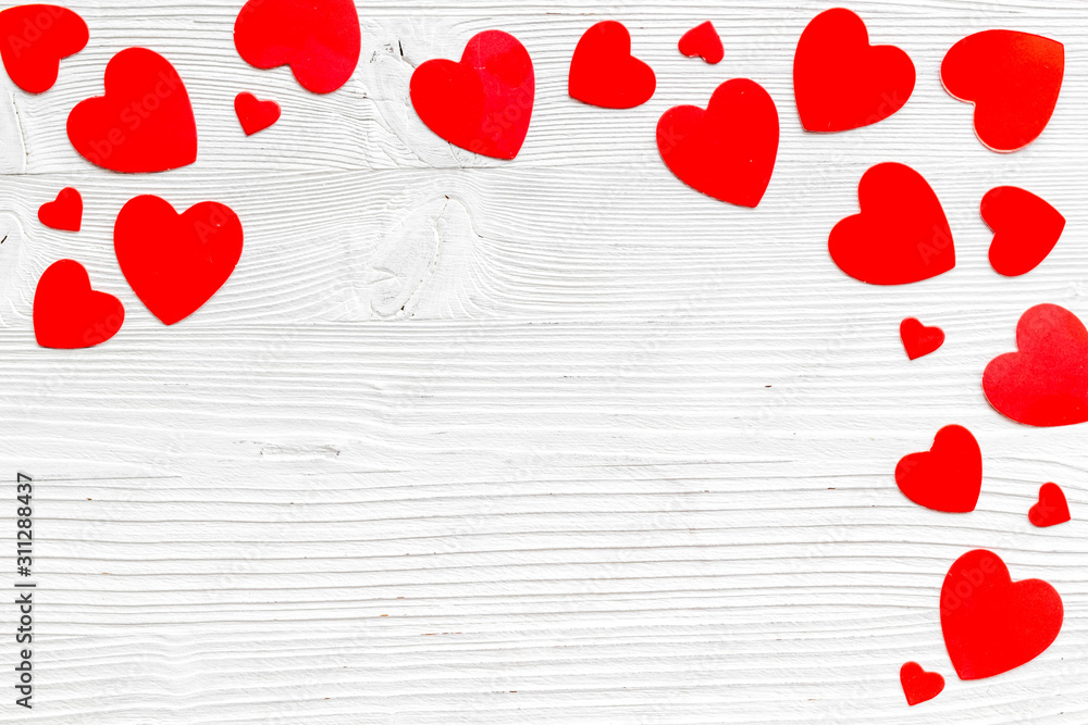 Valentine's Day design. Red hearts frame on white wooden background top-down copy space