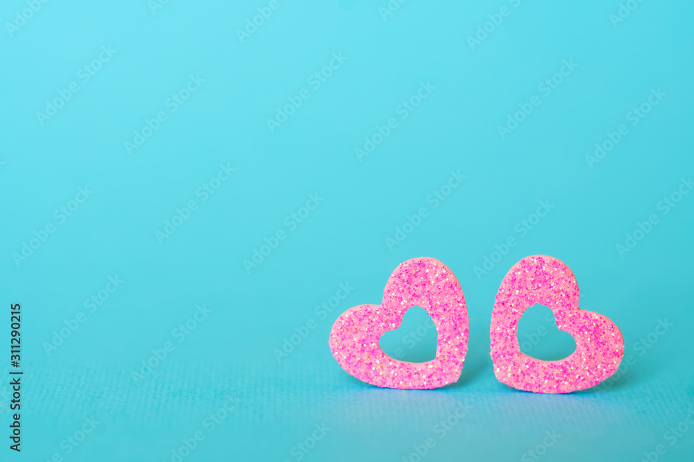 Blue background and two pink hearts. Blank for greeting card. You can insert photos of your favorite people into the hole Blue background and two pink hearts. Blank for greeting card. You can insert photos of your favorite people into the hole