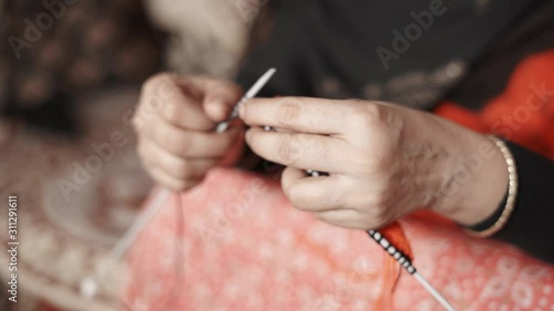 Wallpaper Mural Woman's hands knitting with black thread and two needle crafts. Close up 4k of knit work tie-up hand work Torontodigital.ca